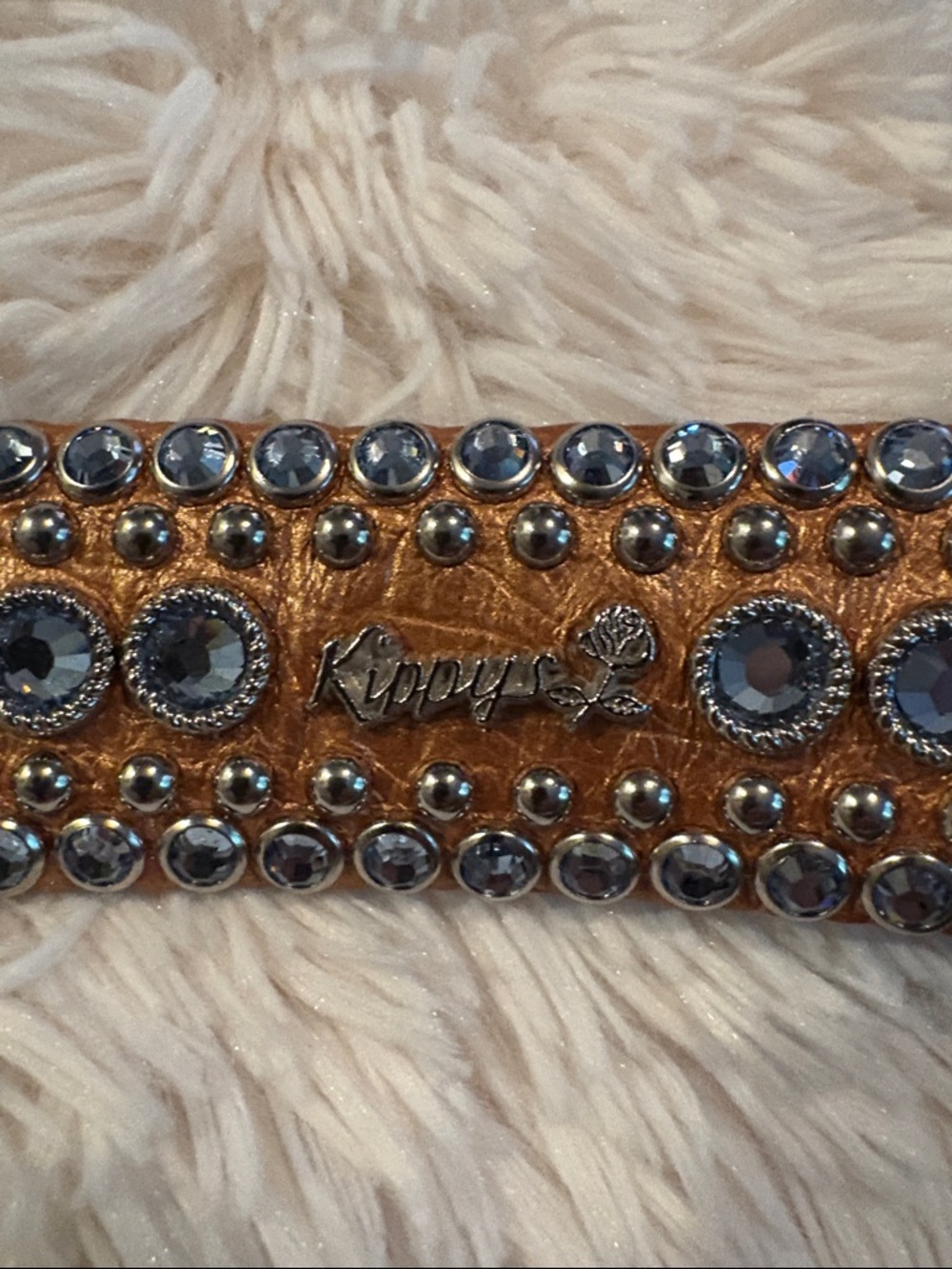 Kippy’s bronze metallic leather belt with light blue Swarovski crystals.